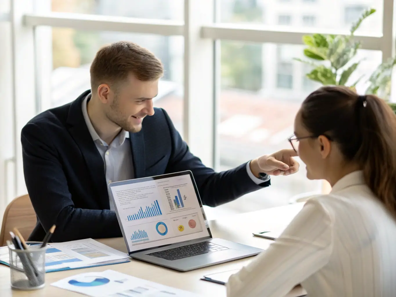 An image of a coach and client engaged in a focused coaching session, with charts and notes on a table, representing the Business Coaching Program.